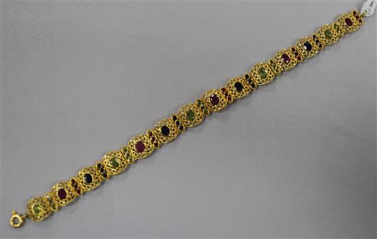 An 18ct gold and polychrome multi gem set filigree bracelet, 17cm.